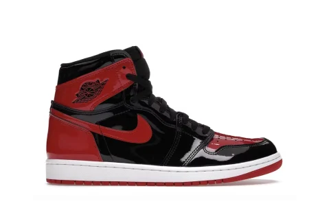 A side view of the Air Jordan 1 High OG ‘Patent Bred’ sneaker, showcasing its black and red patent leather design.