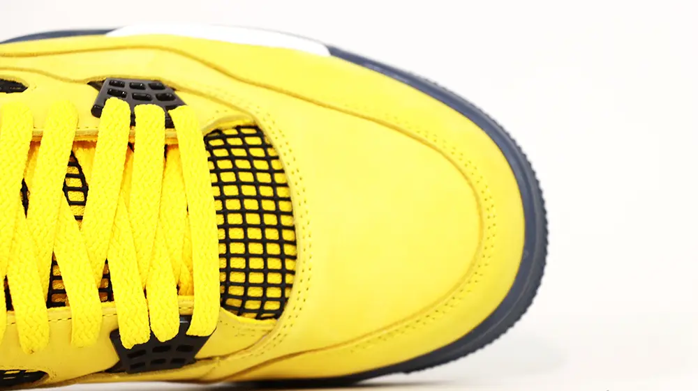 A front view of the toebox on the Jordan 4 Retro ‘Lightning’ (2021), featuring vibrant yellow suede leather.