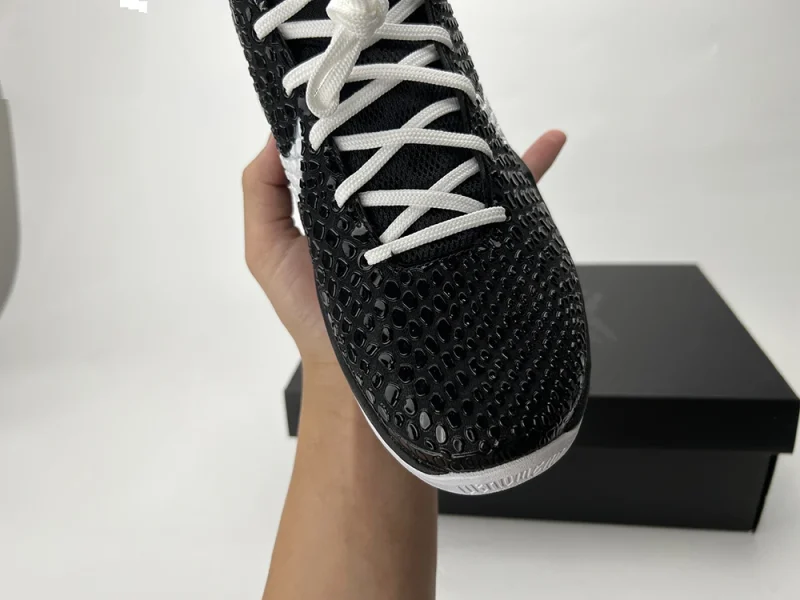 A close-up view of the toebox of the Kobe 6 Protro ‘Mambacita Sweet Sixteen,’ showcasing its predominantly black and white PU material.