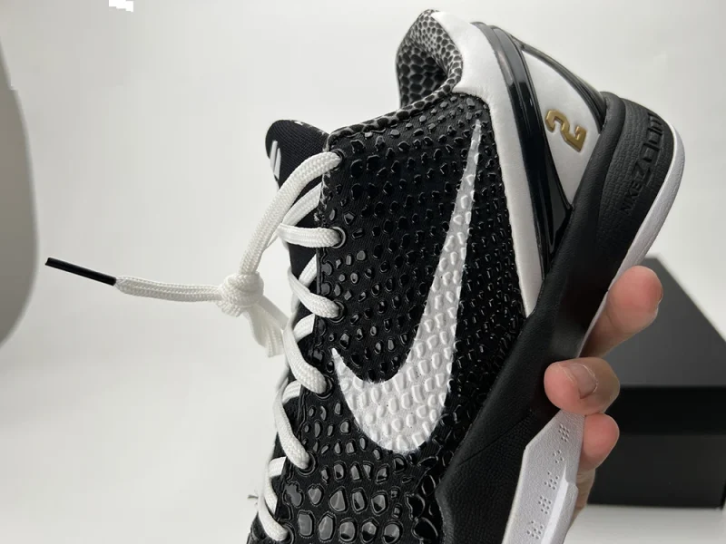 A detailed front view of the inner side of the Kobe 6 Protro ‘Mambacita Sweet Sixteen,’ showcasing the black upper with its snakeskin-style texture