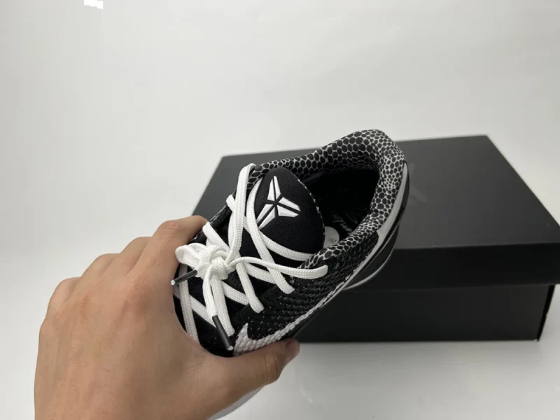 A front view of the tongue and collar of the Kobe 6 Protro ‘Mambacita Sweet Sixteen,’ showcasing the signature Kobe logo and the black-gray cotton collar