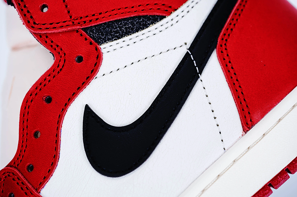 A front view of the outer Swoosh logo on the Jordan 1 Chicago High OG ‘Lost & Found,’ highlighting its black leather material.