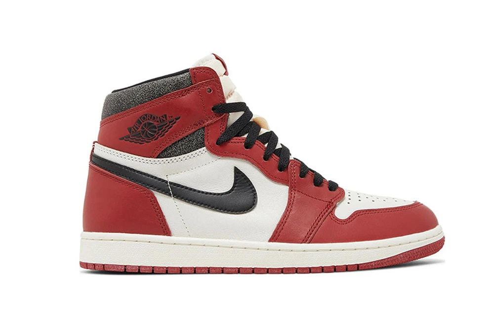 A front view of the outer side of the right shoe of the Jordan 1 Chicago High OG ‘Lost & Found,’ showcasing its overall black-and-red colorway and genuine leather material.