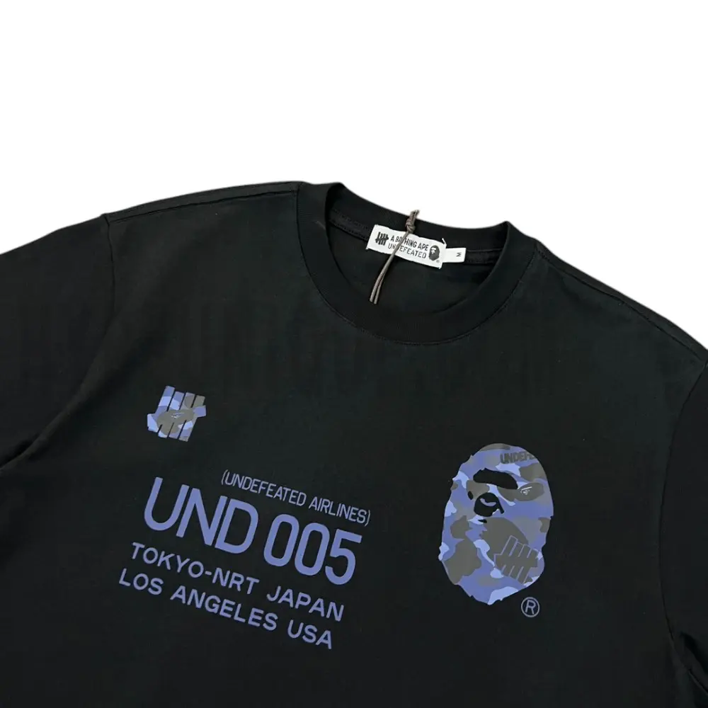 Detailed shot capturing the graphic print on the black tee's front panel.