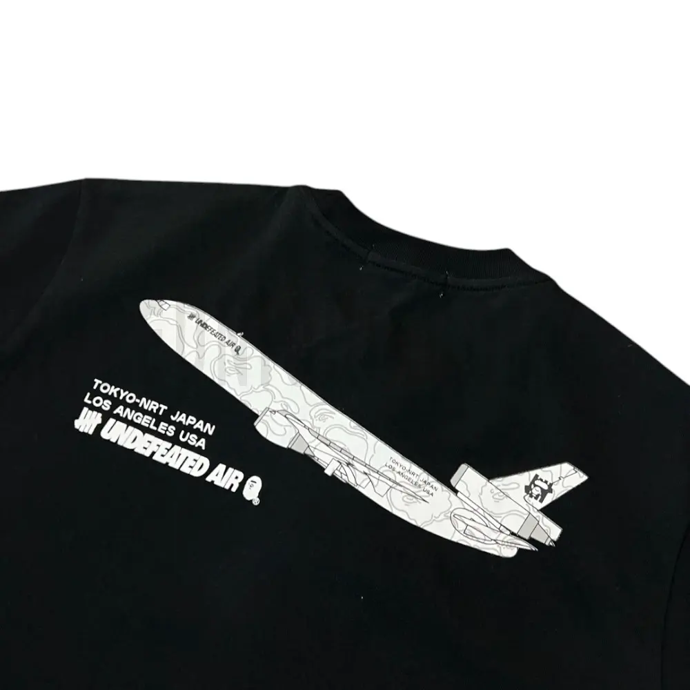 Detailed shot capturing the graphic print on the black tee's back panel.