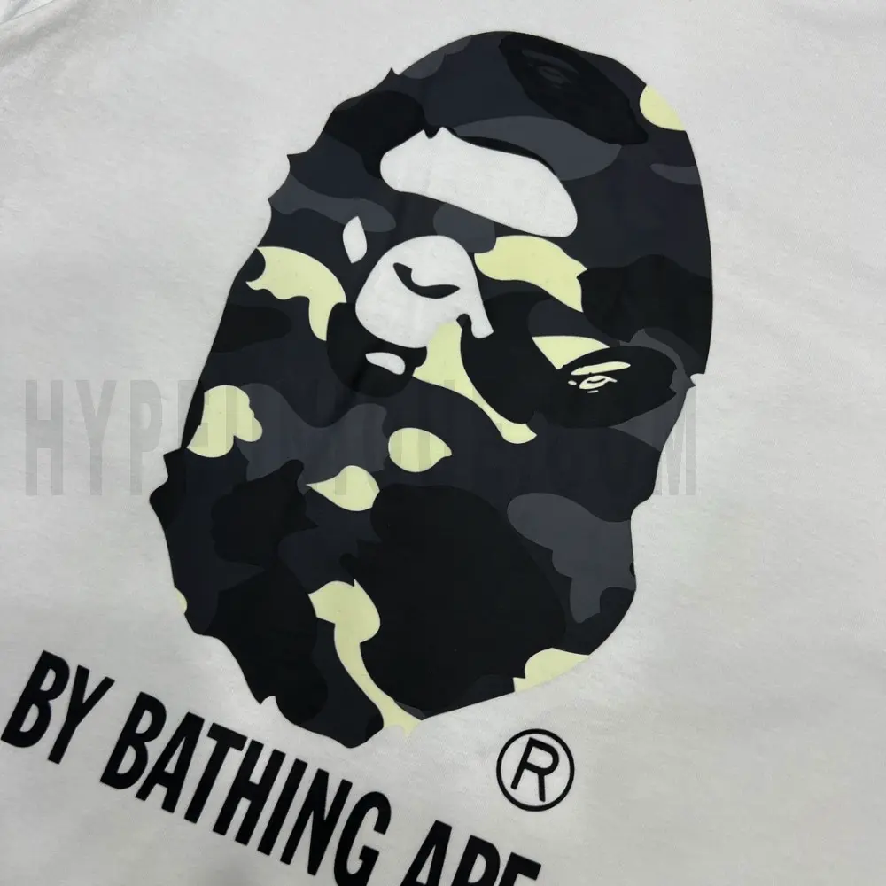 Detailed shot capturing the graphic print on the white tee's front panel.