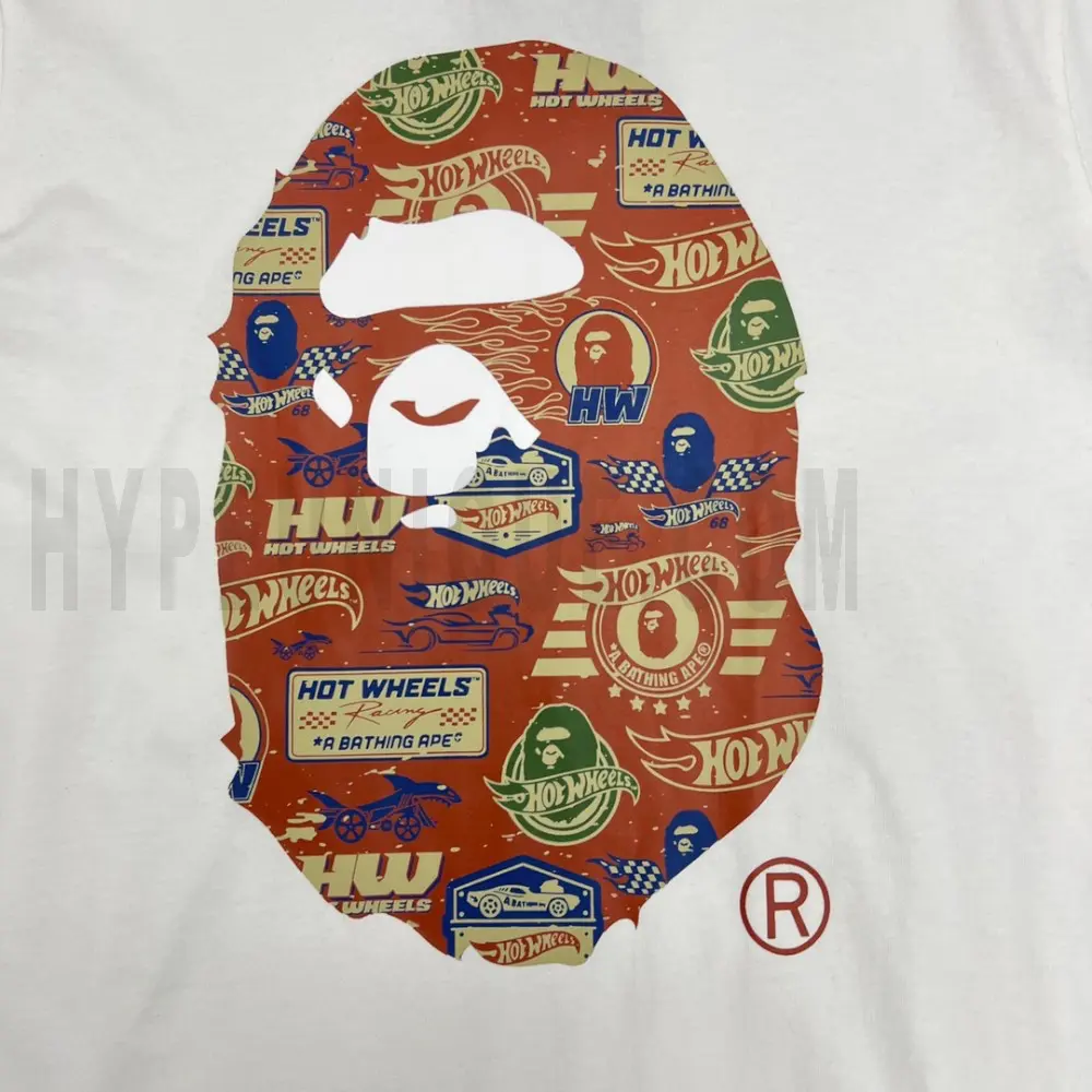 Detailed shot capturing the graphic print on the white tee's front panel.