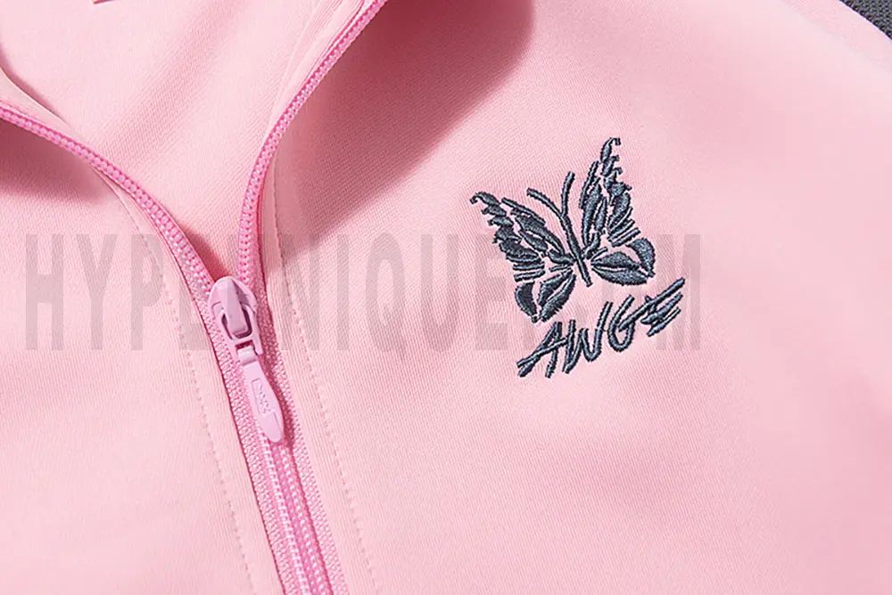 Close-up of butterfly embroidery detail on the chest of the jacket.