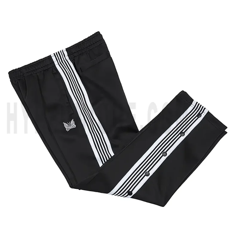 Side view of black track pants.