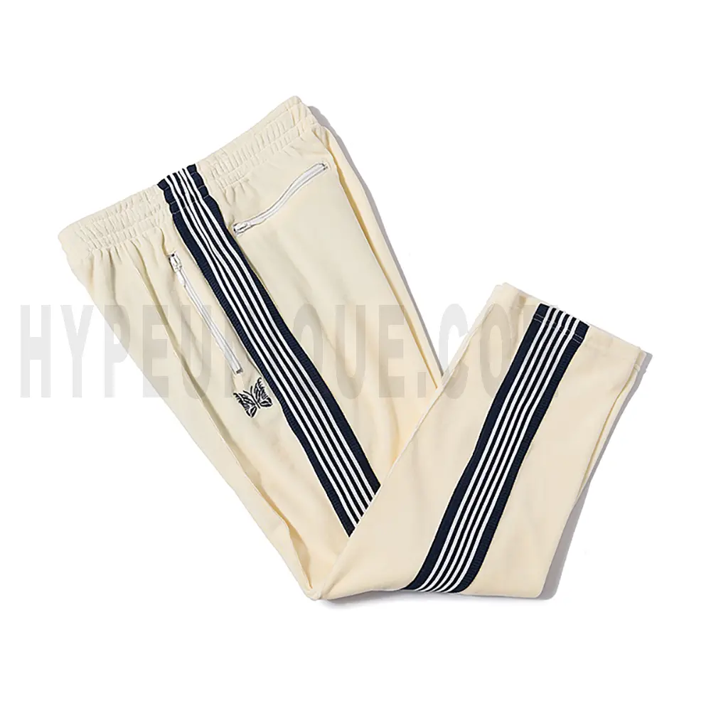 Side view of beige track pants