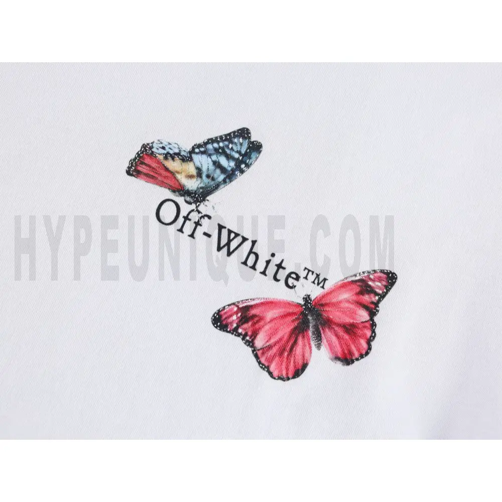 Detailed shot capturing the graphic print on the white tee's front panel.