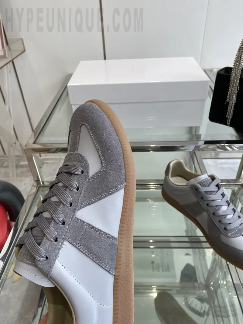 a pair of beige shoes on a glass shelf
