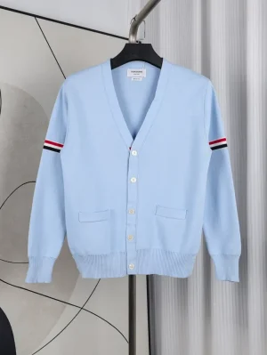 A front view of the Fine Merino Wool RWB Armband Cardigan in light blue, showcasing its light blue merino wool material.