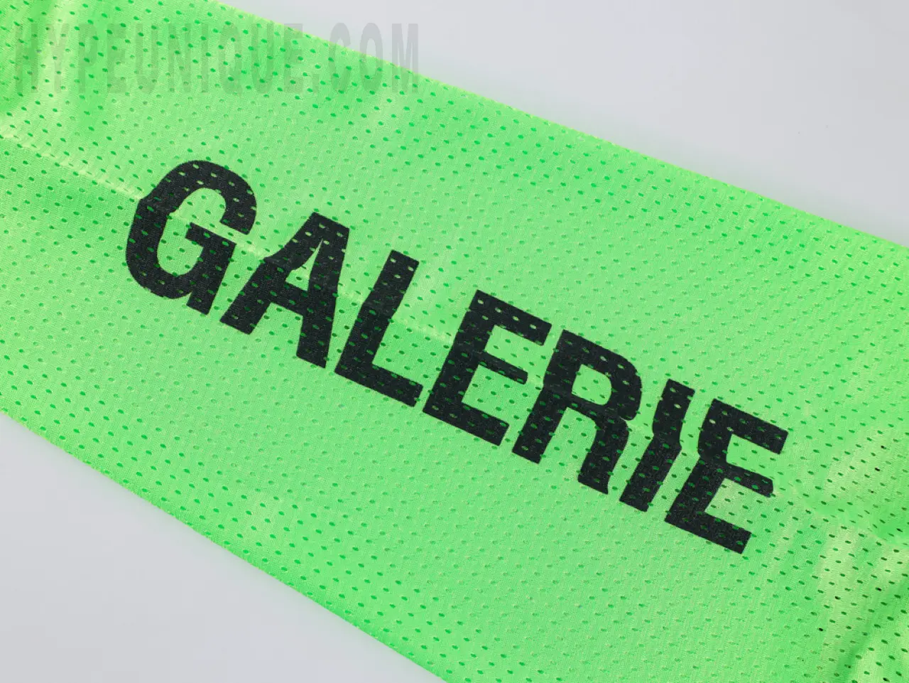 Green sleeves with black offset printing, mainly breathable mesh material.