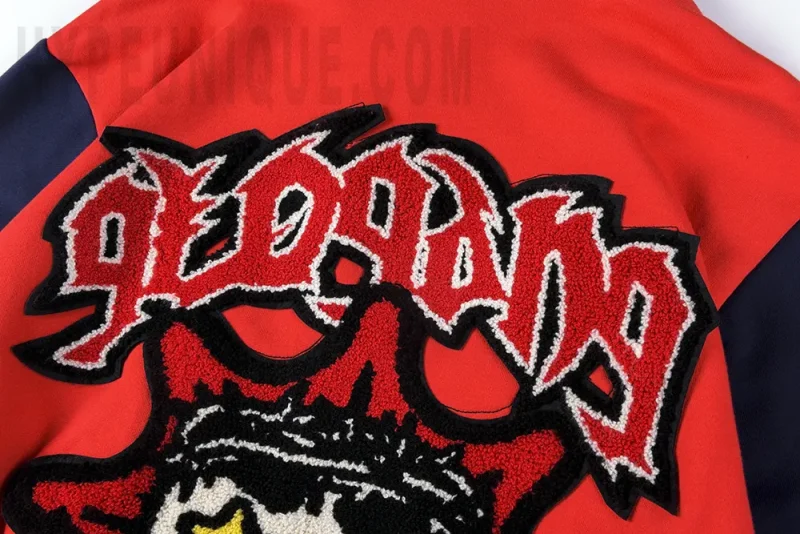 Close-up of the upper back of the Almighty II Gang Full Zip Hoodie (Red/Navy). Showing the glogang gothic design and velvet embroidery.