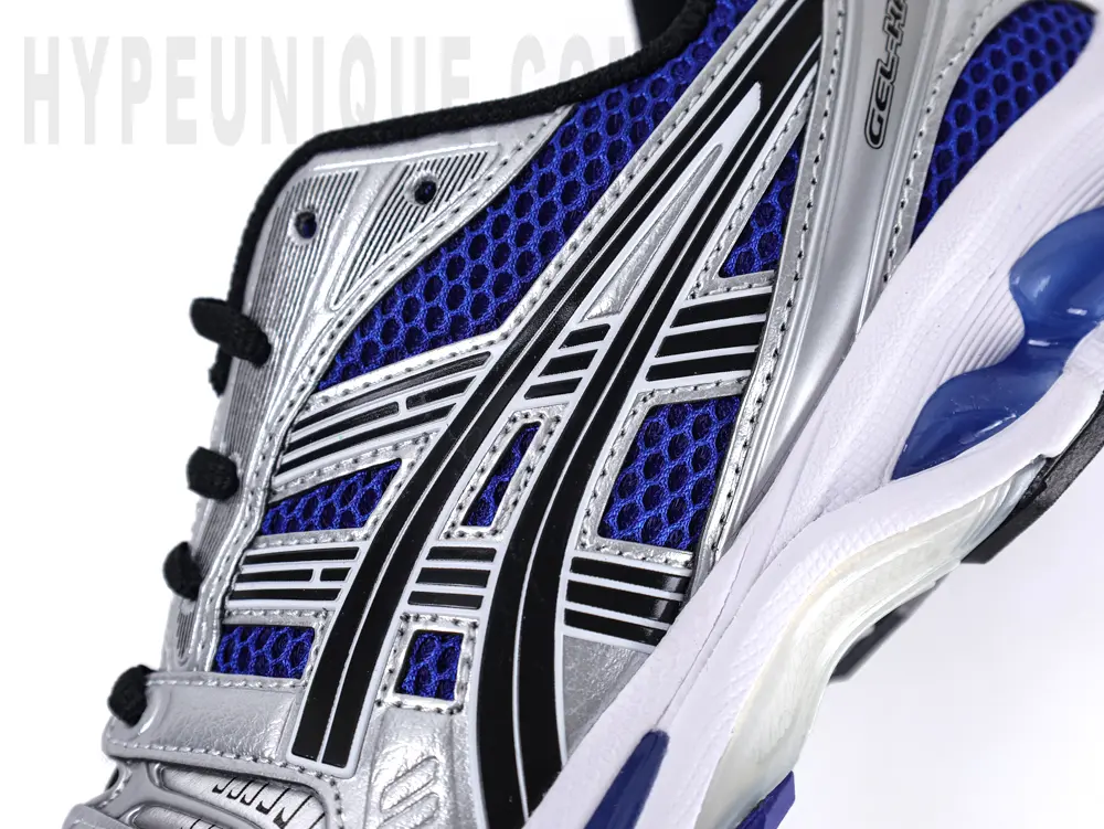 Lateral side view of the ASICS Gel-Kayano 14 “Monaco Blue”, showcasing the metallic silver branding and ventilated mesh construction.