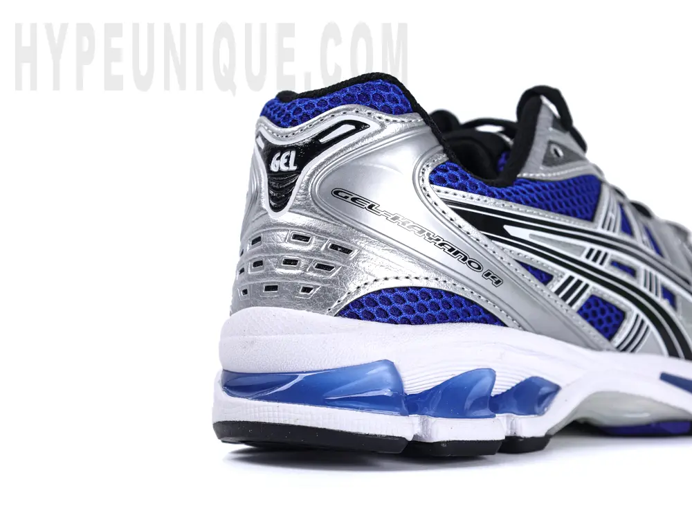 Rear-right view of the ASICS Gel-Kayano 14 “Monaco Blue”, featuring silver leather material on the heel.