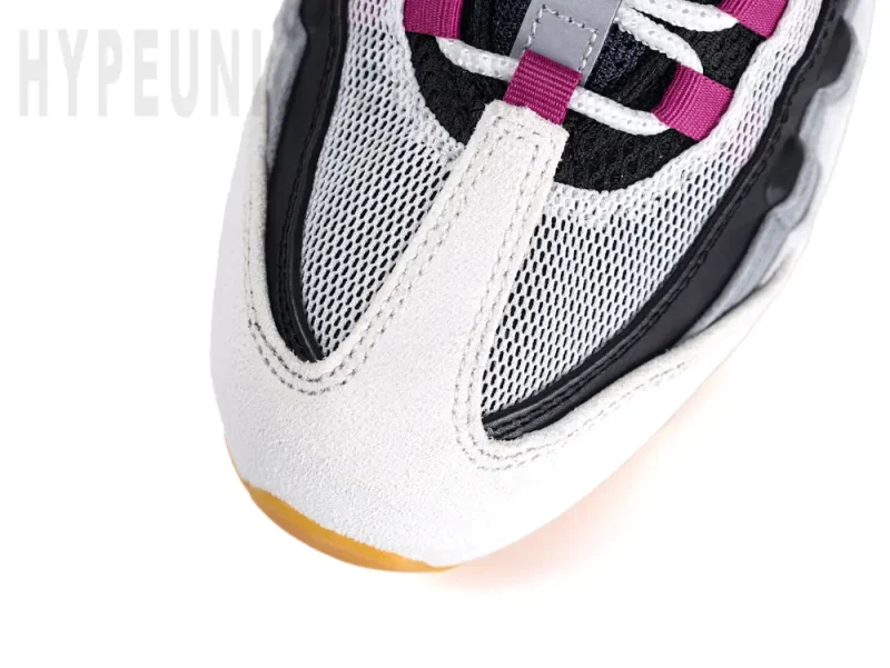 A top-down view of the toe box, showing the white mudguard and mesh toe box.
