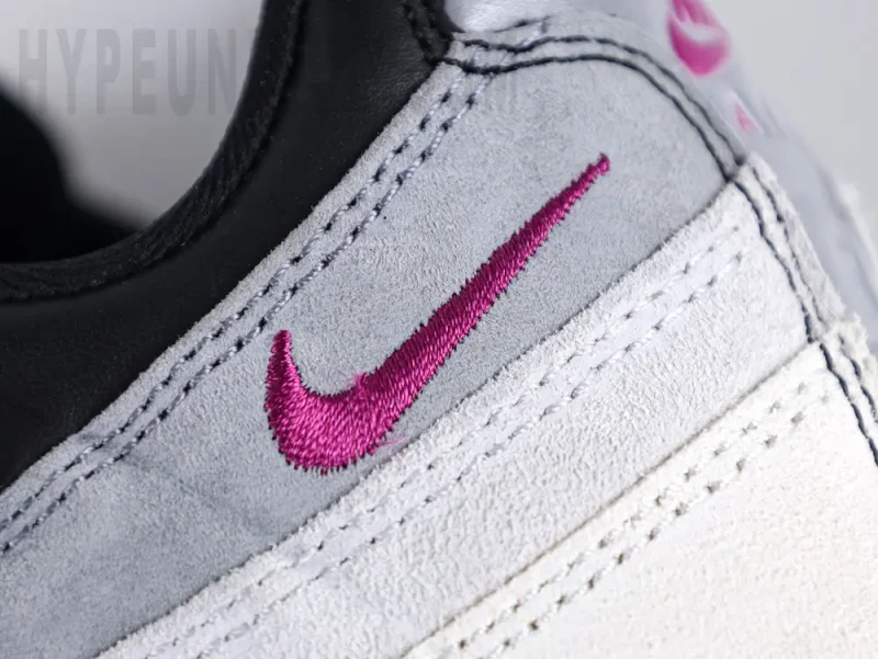 Purple embroidered Swoosh logo on the side of the heel