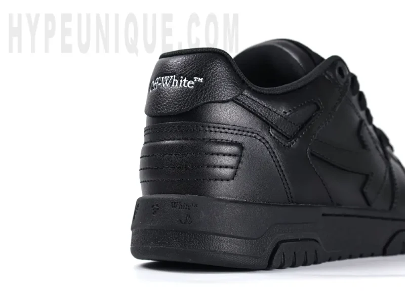 Close-up view of the rear right side of the black leather heel of the Off-White Out of Office Low 'Triple Black'.