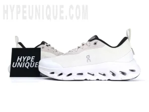 Front view of the left shoe's lateral side in the On Cloudtilt Loewe 2 WMNS Sand / White. Showcasing the minimalist design in all white.