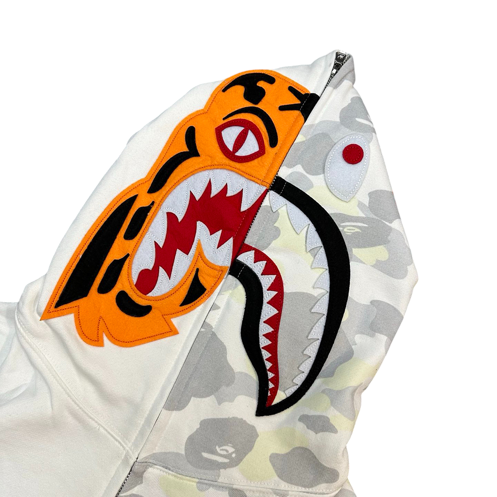 A tiger's face on the left, and the Bape logo on the right.