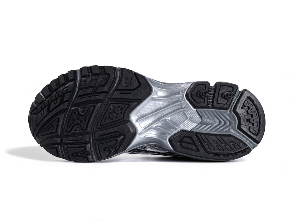 Silver athletic shoe with black sole