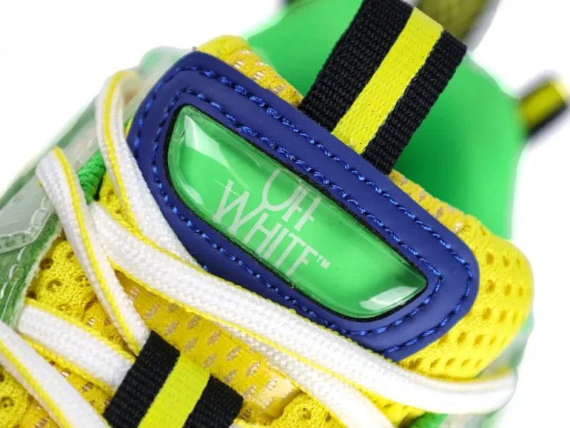 Green transparent plastic brand logo on the shoe tongue