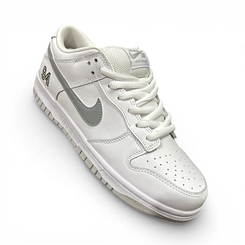 Three-quarter angle view of white low-top sneaker highlighting overall shape and silver swoosh detail
