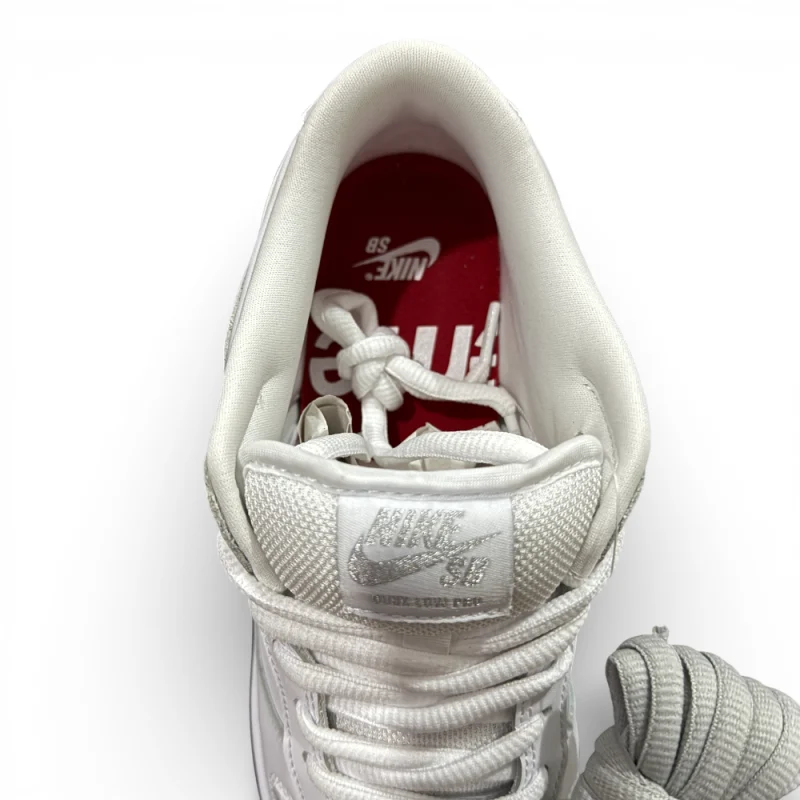 Top view of sneaker interior showing padded lining, tongue label, and lace arrangement