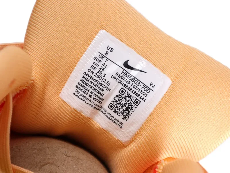 Nike running shoe in orange and pink