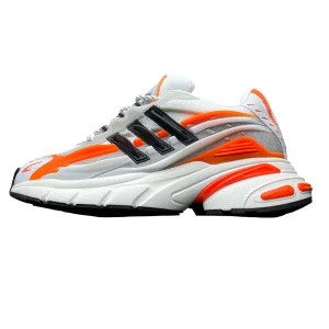 The image shows a sneaker sole with textured black rubber, white highlights, and vibrant orange accents, featuring intricate treads.