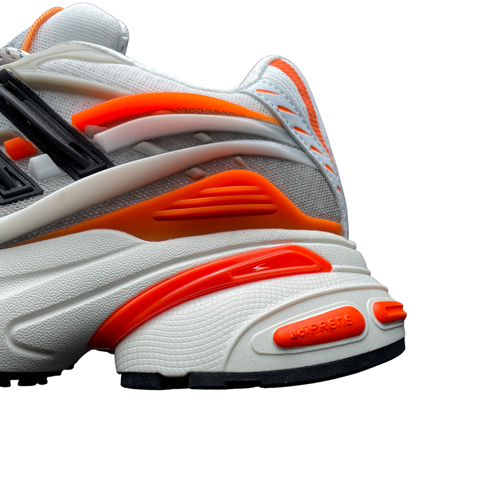 Close-up of a sneaker with white mesh, vibrant orange accents, and black detailing. Dynamic curves emphasize texture and design.