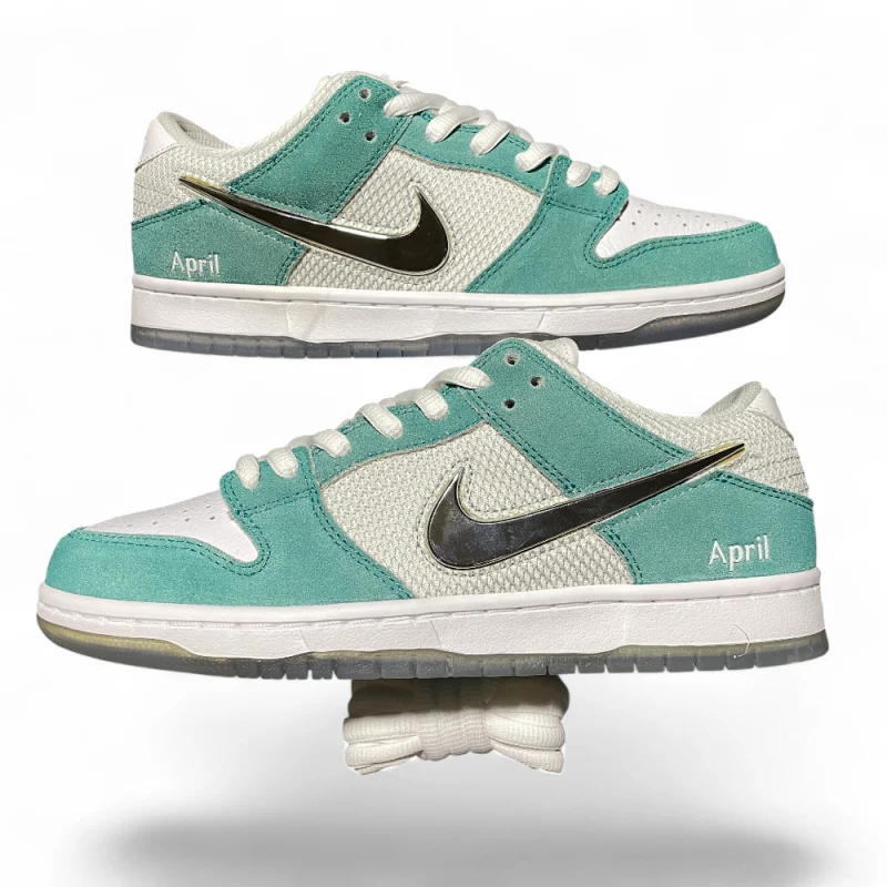 Mint and white sneakers with suede and mesh textures, featuring a metallic swoosh and "April" text, positioned in profile.