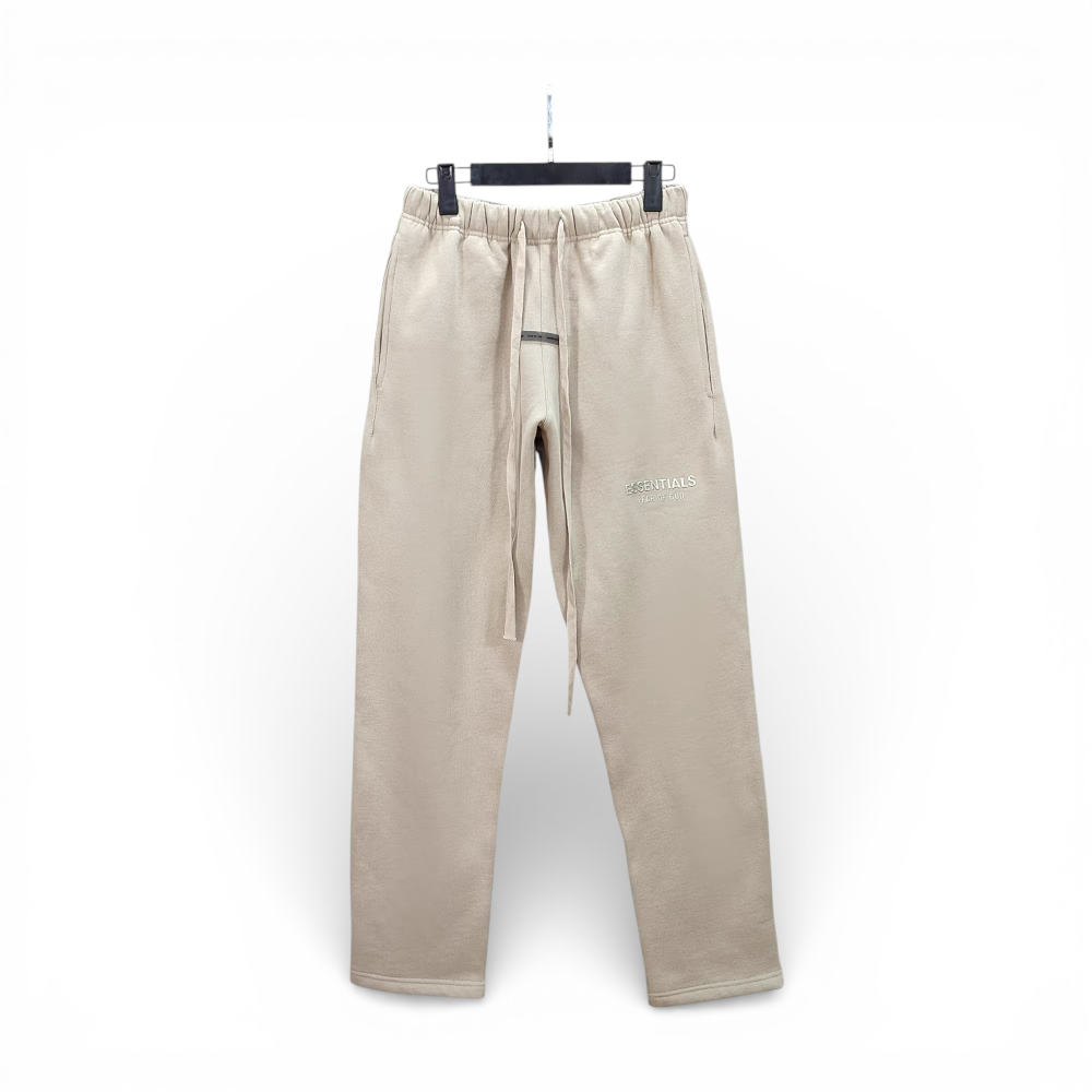 Beige cotton sweatpants with drawstring waistband and side pockets, displayed on hanger.