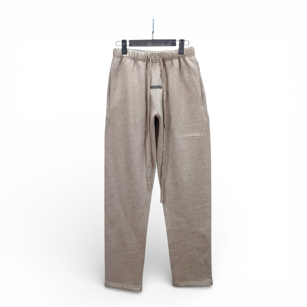 Tan cotton sweatpants with drawstring waist and front pockets, hanging on a hanger.