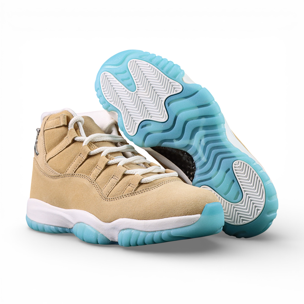 Beige suede sneakers with white laces and blue rubber soles.