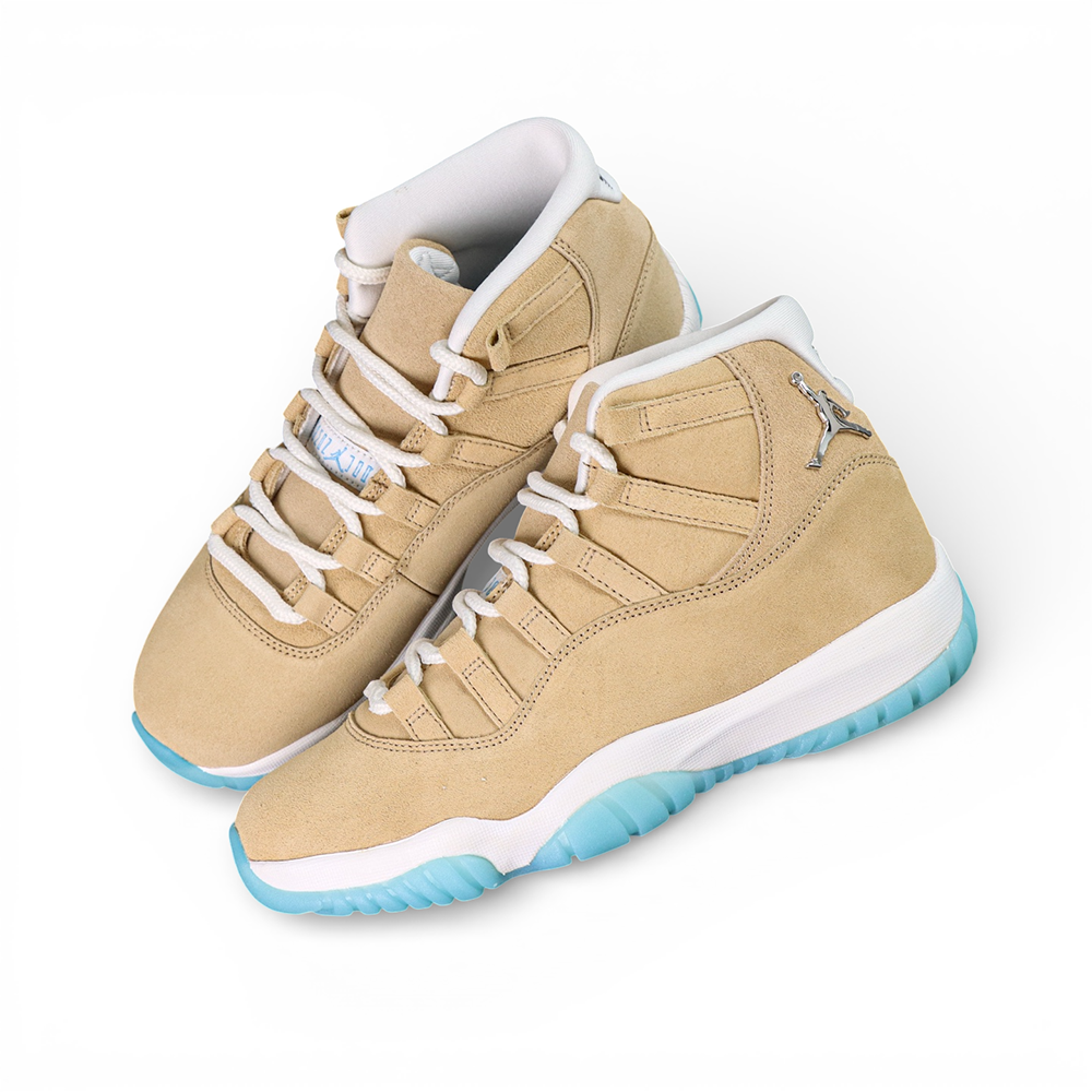 Beige suede basketball shoes with white laces and light blue translucent soles.