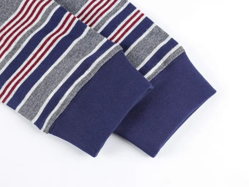 Cuffed sleeves with navy fabric, gray, red, and white stripes. Soft texture and horizontal lines create a cozy look.