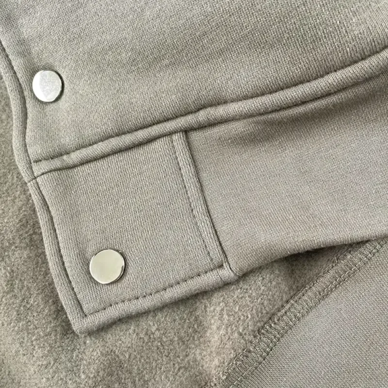 Gray fabric buckle with metal buttons.