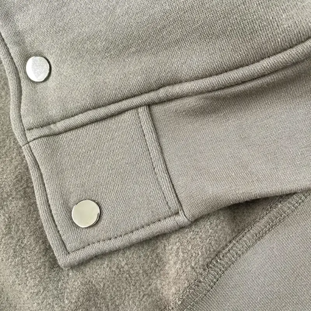 Gray fabric buckle with metal buttons.