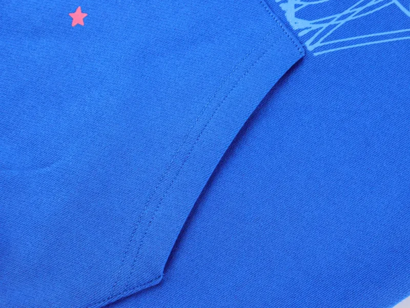 Close-up of blue fabric featuring red star detail and visible stitched seam.