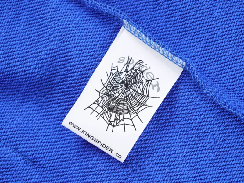 Close-up of a blue fabric label on a textured knit garment.