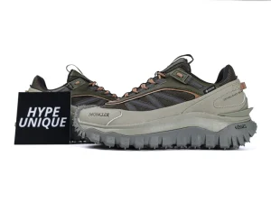 Green and beige sneakers featuring mesh and leather, rugged sole, angular design, with a prominent black “Hype Unique” sign.