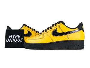Yellow leather sneakers with black accents and rubber sole, displayed on white background.