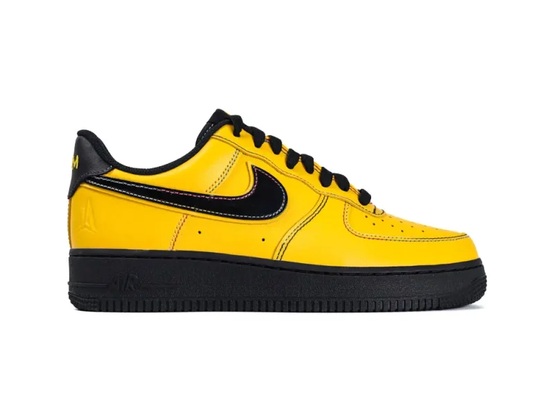 Yellow leather sneaker with black accents and sole, featuring a prominent swoosh.