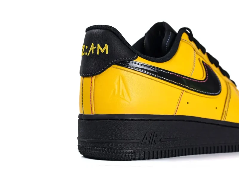 Yellow leather sneaker with black accents, featuring a durable rubber sole.