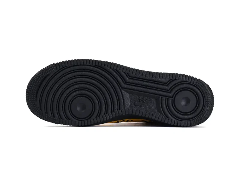 Black rubber shoe sole featuring circular tread patterns for enhanced grip and durability.