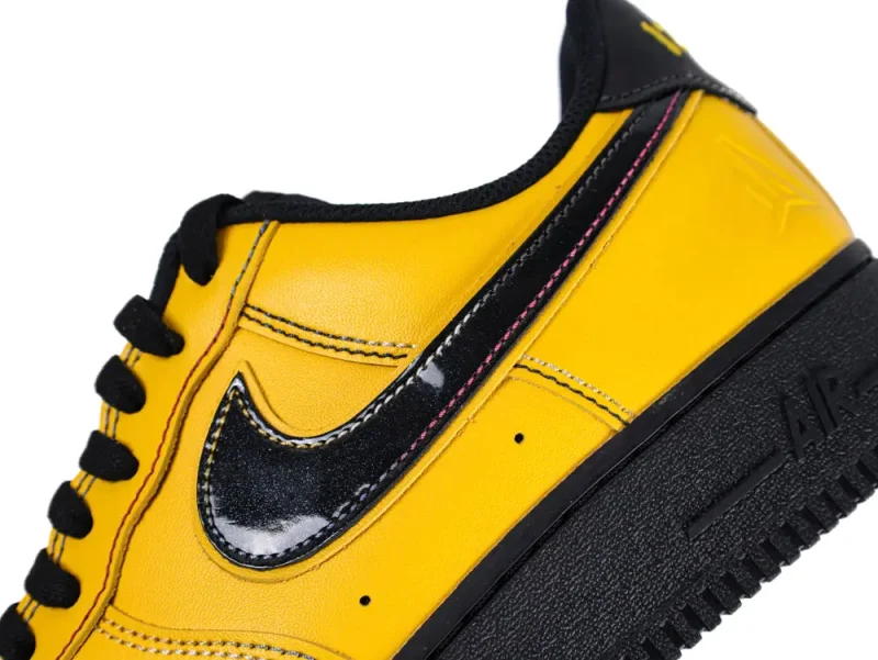 Yellow and black fabric sneakers, focus on padded collars and branded insoles.
