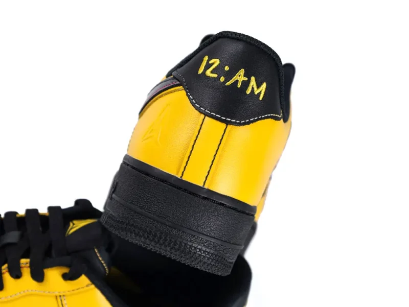 Yellow and black leather sneaker heel with "12:AM" text.